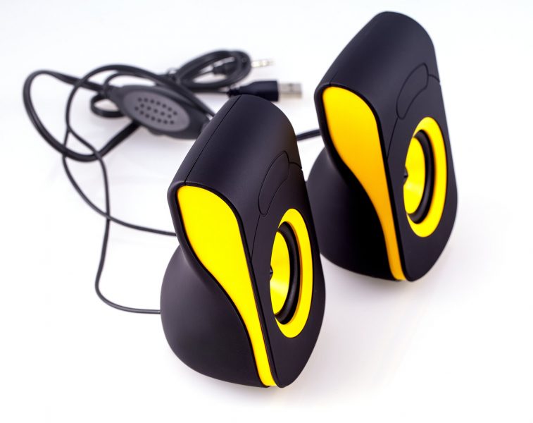 computer speakers with yellow and black design on isolate white background
